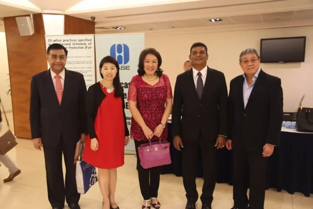 Direct selling association of singapore heads posing for a photo with QNET's head of legal affairs. 