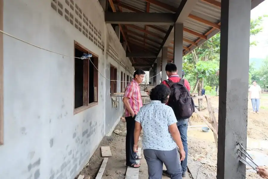 open window classrooms with teachers walking on outside of classrooms