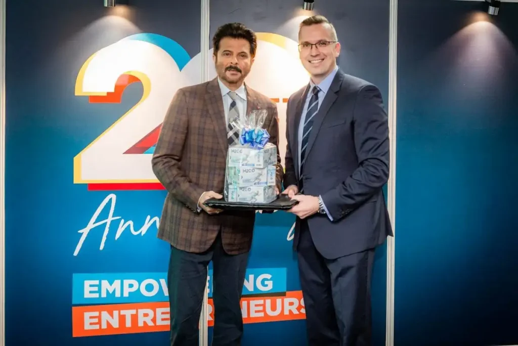 Anil Kapoor holding QNET product with Trevor Kuna