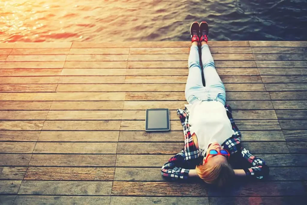 Man taking a breaking laying down on lake relaxing