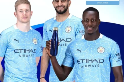 Three men in Etihad jerseys holding homePure water bottles, promoting healthy hydration practices