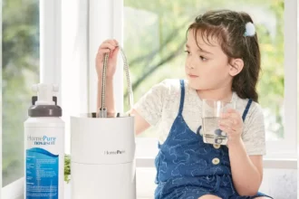 A girl seated, hydrating with HomePure, while reaching for the adjacent HomePure-NovaSoft-Solution-To-Hard-Water