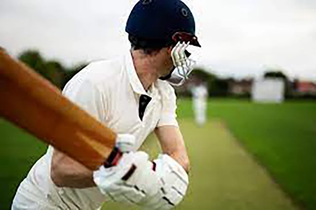 Man winding up to swing cricket bat during cricket game