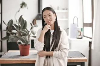 Woman sitting on office desk thinking