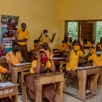 Children in Ghana learning inside a classroom, with the support of ANOPA, QNET and RYTHM Foundation