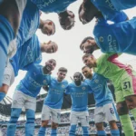 QNET-ManCity players, who have just been named Champions of the World 2023, huddle up before a game