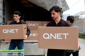 QNET Ramadan 2023 - Men carrying donation packages