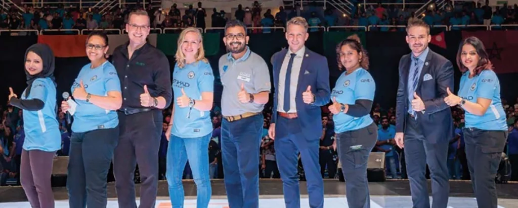 MrTrevor Kuna and chief Pathman posing with Manchester City womens team on stage 