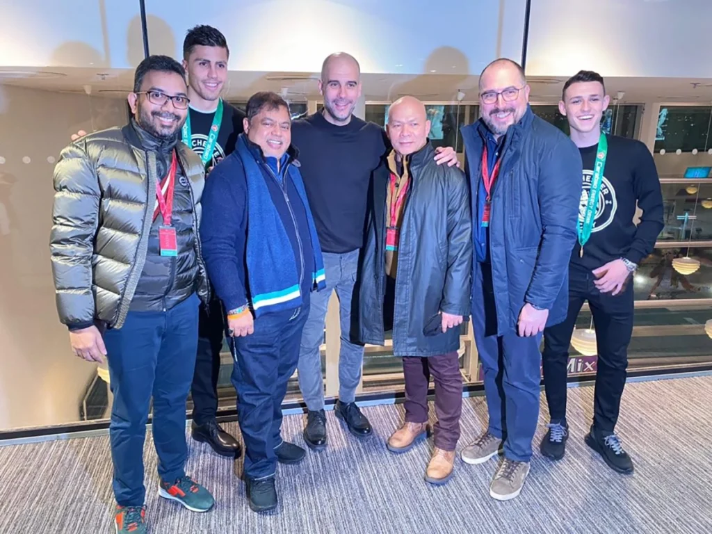 QNET directors and founders posing with Manchester City players. 