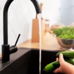 Cleaning vegetables at kitchen sink