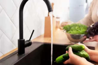 Cleaning vegetables at kitchen sink