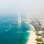 Stunning Dubai cityscape with water, merging urban and aquatic beauty.