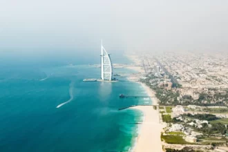 Stunning Dubai cityscape with water, merging urban and aquatic beauty.