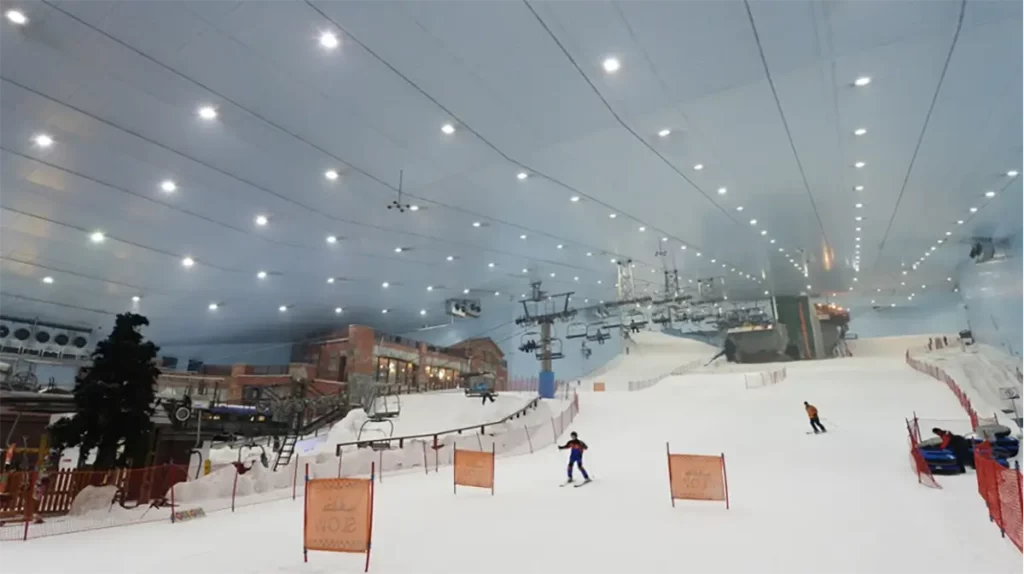 people skiing inside indoor winter facility