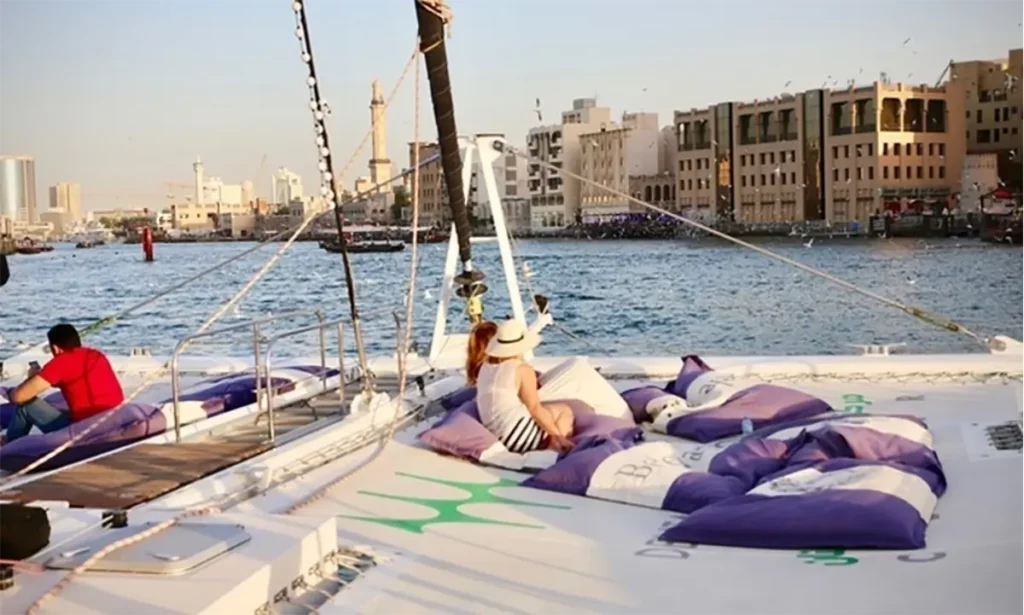 People relaxing on a yacht on a river during sunset