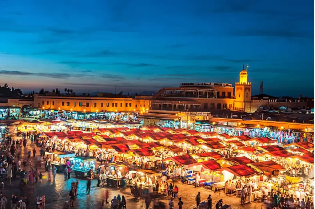 Djemaa El Fna Square at dusk with Koutoubia Mosque, Marrakesh, Morocco