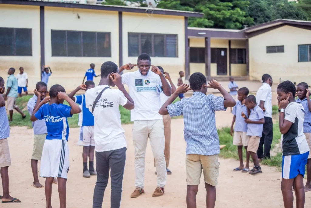Children with visual and hearing impairments in Cape Coast, Ghana playing games outside
