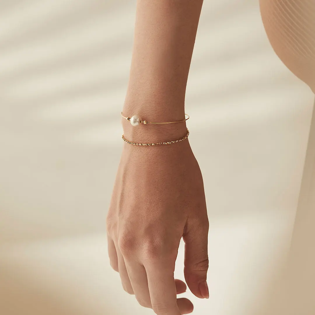 Wrist adorned with a Greta Bracelet showcasing an Akoya Pearl, from Bernhard H. Mayer