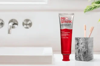 ProSpark toothpaste and wooden toothbrushes in a holder beside a bathroom sink