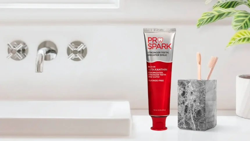 ProSpark toothpaste and wooden toothbrushes in a holder beside a bathroom sink