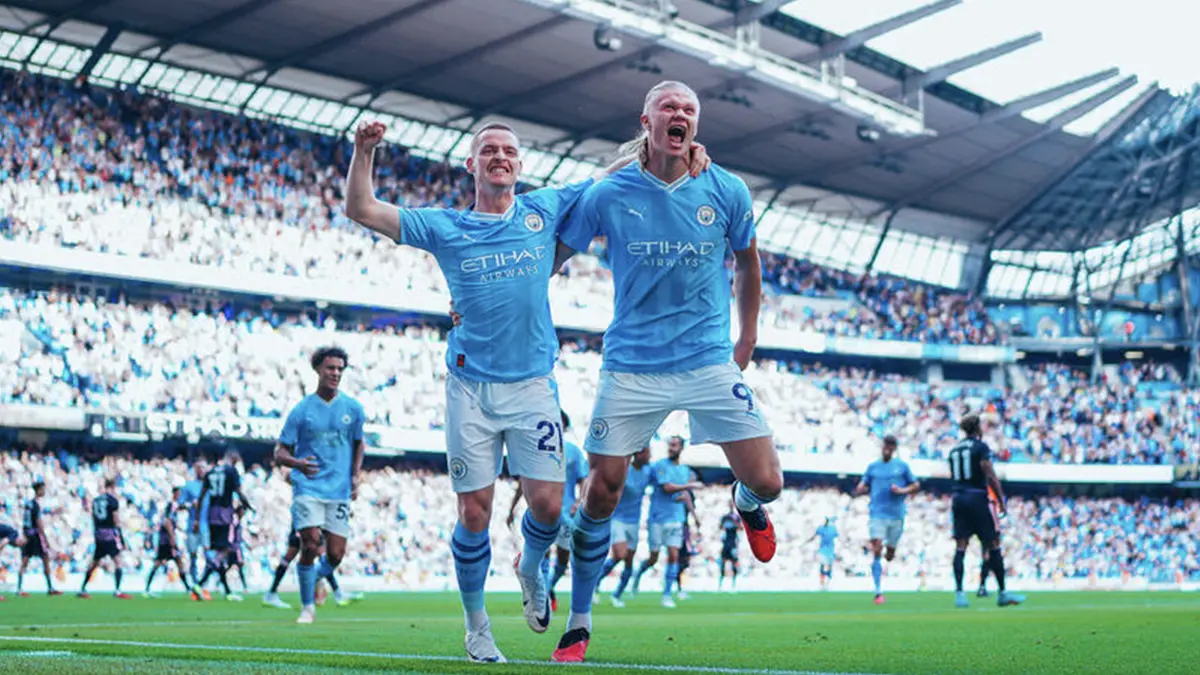 Erling Halland and Sergio Gomez of Manchester City FC celebrating with arms around each other