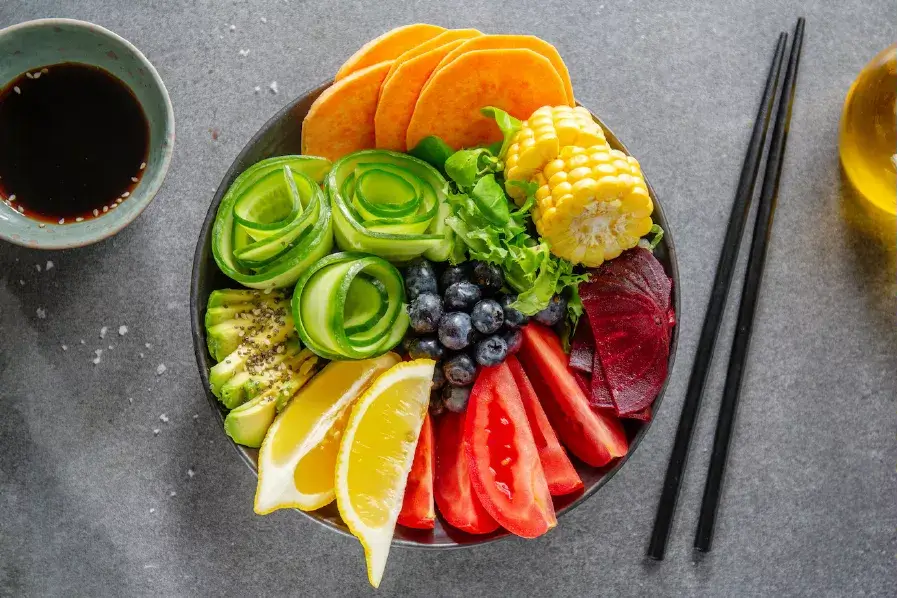 Bowl of vegetables on table with chopsticks