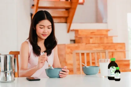 Girl having breakfast with Ole Olive Leaf Extract on the table