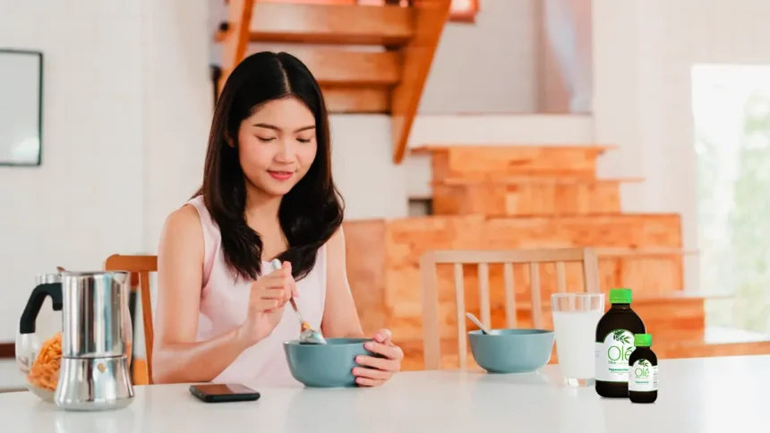 Girl having breakfast with Ole Olive Leaf Extract on the table