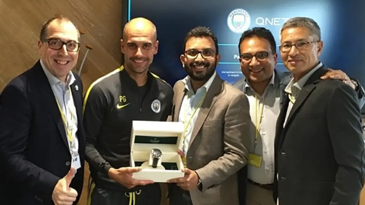 Man City Coach Pep Guardiola posing with QNET Directors and the QNETCity Watch by CIMIER