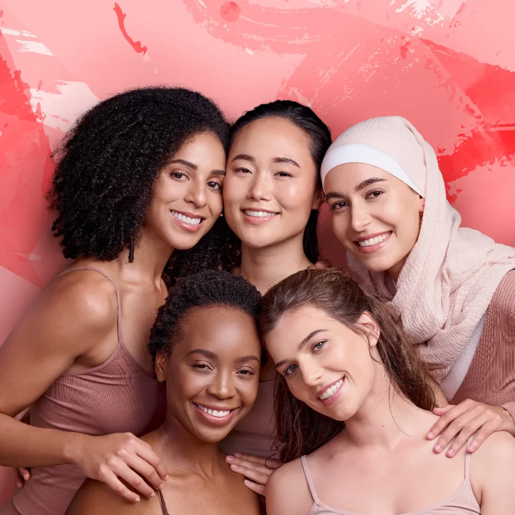 Multicultural group of women posing together in a pink themed photo 