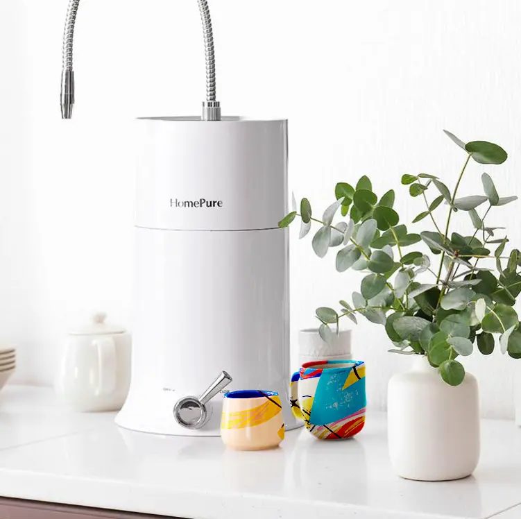 HomePure Nova on a kitchen table surrounded by cups, a teapot and a plant