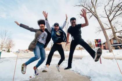 Three friends jumping in the air from the joy of experiencing QNET Products