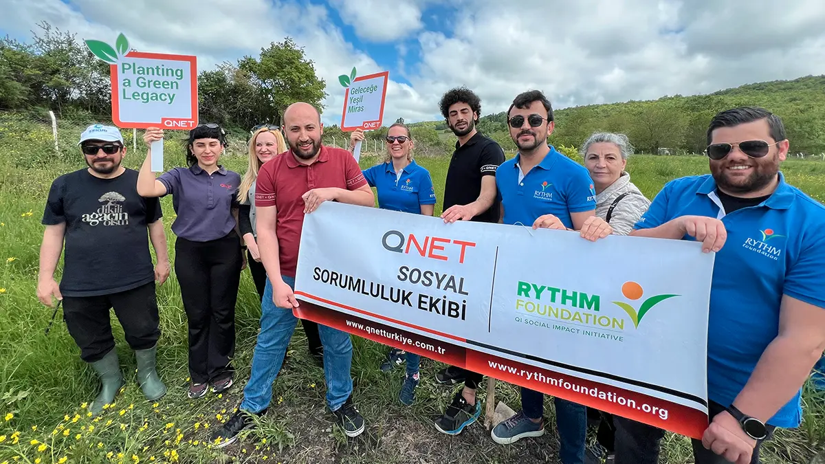 Championing Sustainability And Building A Green Legacy With Qnet 6 QNET Turkey staff pose with RYTHM Foundation banner and QNET Green Legacy placards to commemorate planting 2000 trees in Istanbul on May 2024.