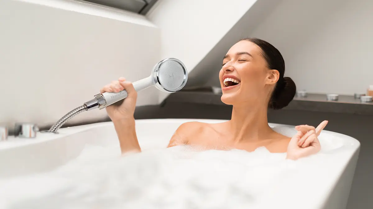 Homepure Rayn Brings You The Best Shower Of Your Life 2 Lady in bathtub using HomePure Rayn shower head as a microphone