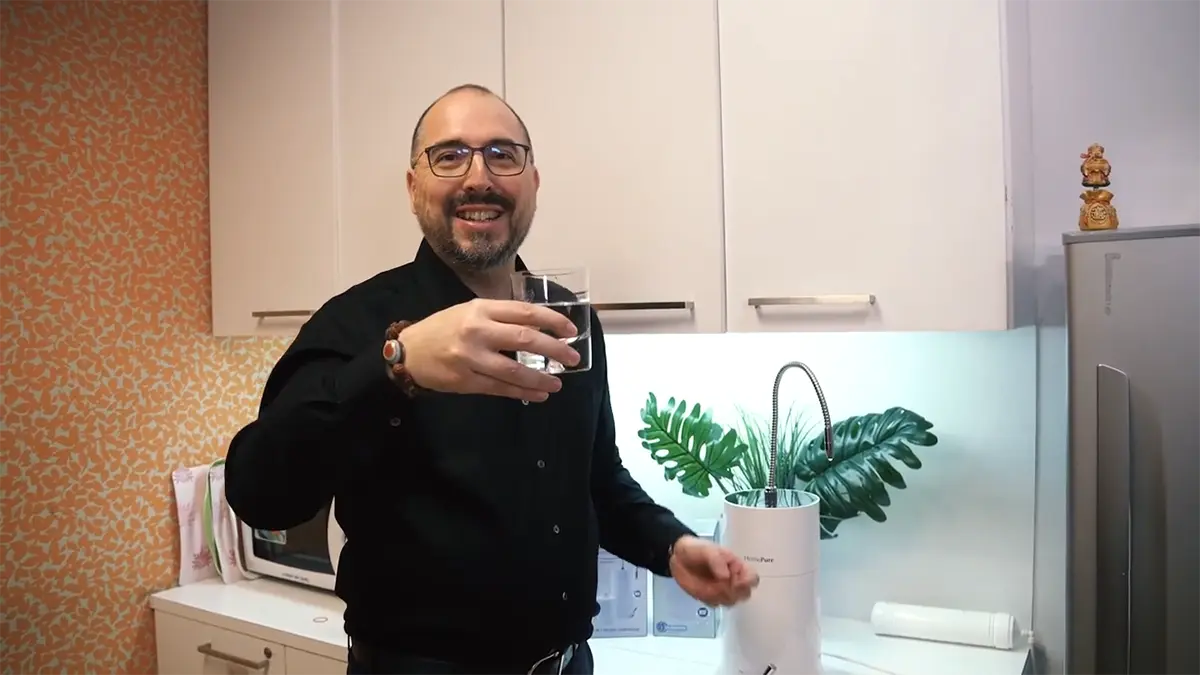 7 Unexpected Places To Experience The Power Of Homepure Nova’s Clean Water 6 QI Director of International Operations JR Mayer holding up a glass of HomePure water at a QNET office