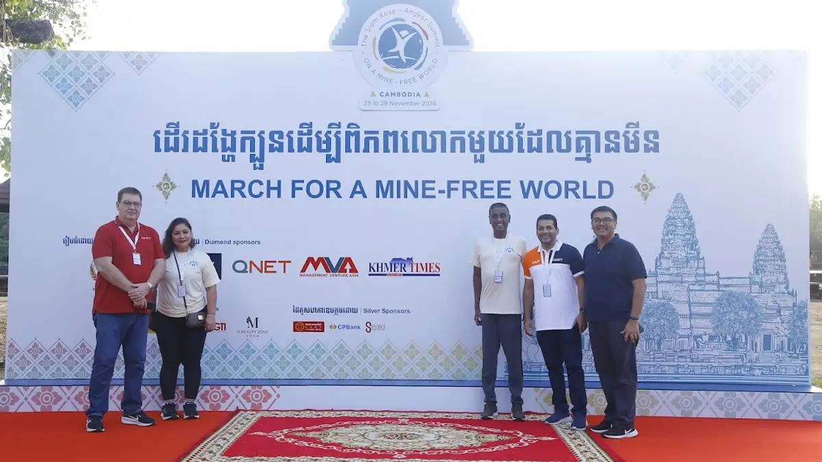 Qnet Champions A Mine-Free Cambodia At Global Summit 3 QNET Deputy CEO Jean François Huertas, QNET Chief of Regional Operations Pushpalatha Balan, and other QNET Corporate representatives in front of the stage with QNET's logo listed as one of the sponsors of the March for a Mine-Free World event